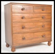 A Victorian 19th century flame mahogany 2 over 3 two tone chest of drawers being raised on bun