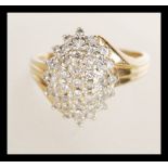 A 9k stamped 9ct gold and diamond ring having pave set cluster of white stones. Weighs 4.2 grams