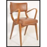 A vintage retro 20th Century Ben Chairs armchair raised on shaped angular legs with leather / faux