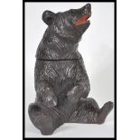 A German Black Forest hand carved wooden tobacco pot or tea caddy in the form of a bear having