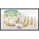 A small collection of 20th Century Art Deco Clarice Cliff items to include a Taormina toast rack,