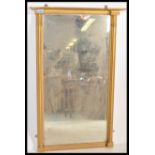 A 19th century gilt wood and gesso bevelled glass wall mirror having a rectangular mirror flanked by