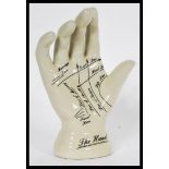 A vintage style Phrenology type Palmistry ceramic hand having instructions to palm. Measures 19 cm