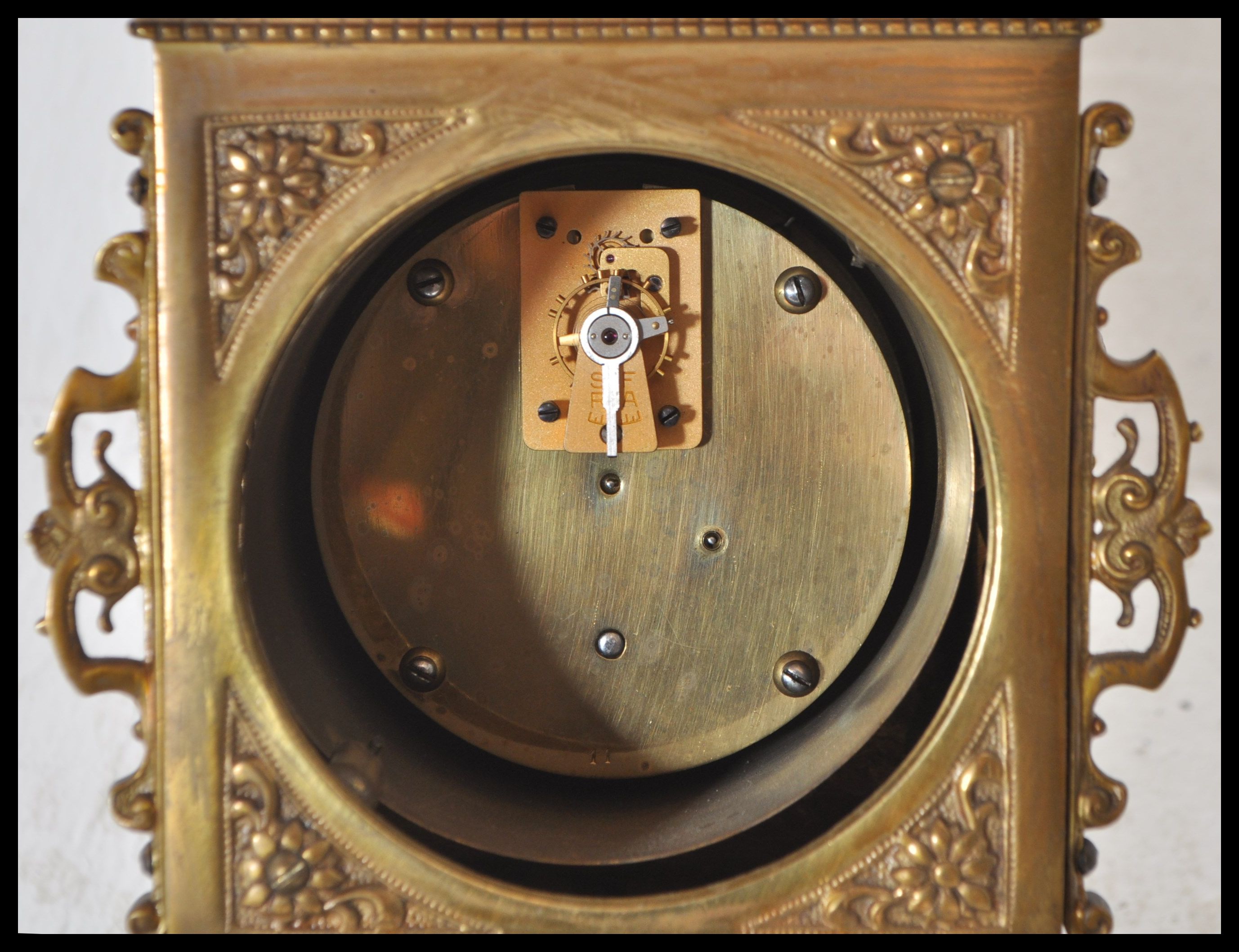 A 19th Century Victorian gilt brass mantel clock raised on a bracket base with armorial decoration - Image 6 of 6