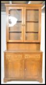 An early 20th Century oak dresser / bookcase cabinet raised two over two cupboard drawer base with