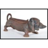 An early 20th Century cast iron boot scraper scrape in the form of a Dachshund dog. Measures 15 cm