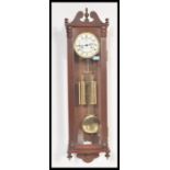 A 20th Century double weighted Vienna style pendulum wall clock with a swan's neck pediment to the