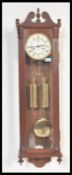 A 20th Century double weighted Vienna style pendulum wall clock with a swan's neck pediment to the