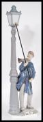 A Lladro ceramic figurine entitled Lamp post Lighter depicting a man lighting a Victorian lamp