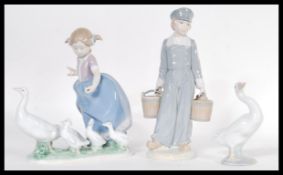 Three Lladro porcelain figurines to include ' Dutch Boy With Pails ', a figurine of a girl herding