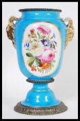 A 19th Century French ceramic urn vase in the manner of Serves having a powder blue ground with
