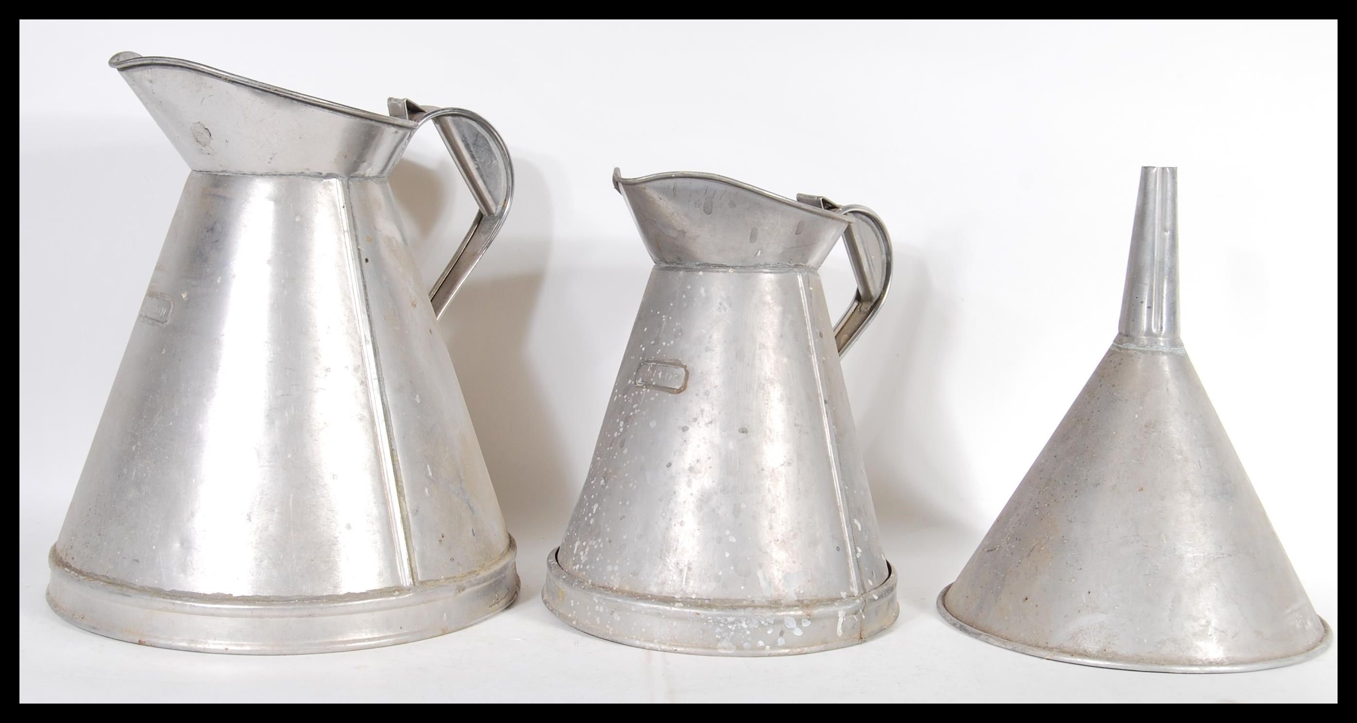 Two vintage industrial dairy milk jugs of graduating size measuring two gallons and one gallon along - Image 2 of 8