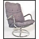 A 20th century retro vintage swivel / lounge chair armchair comprising of a polished metal frame