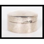 A 20th Century hallmarked silver pill box or counter case of cylindrical form having hinged circular