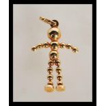 A hallmarked 9ct gold necklace pendant in the form of an articulated man with ball head and