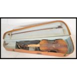 A vintage early 20th Century 3/4 size violin musical instrument having a two piece maple back with