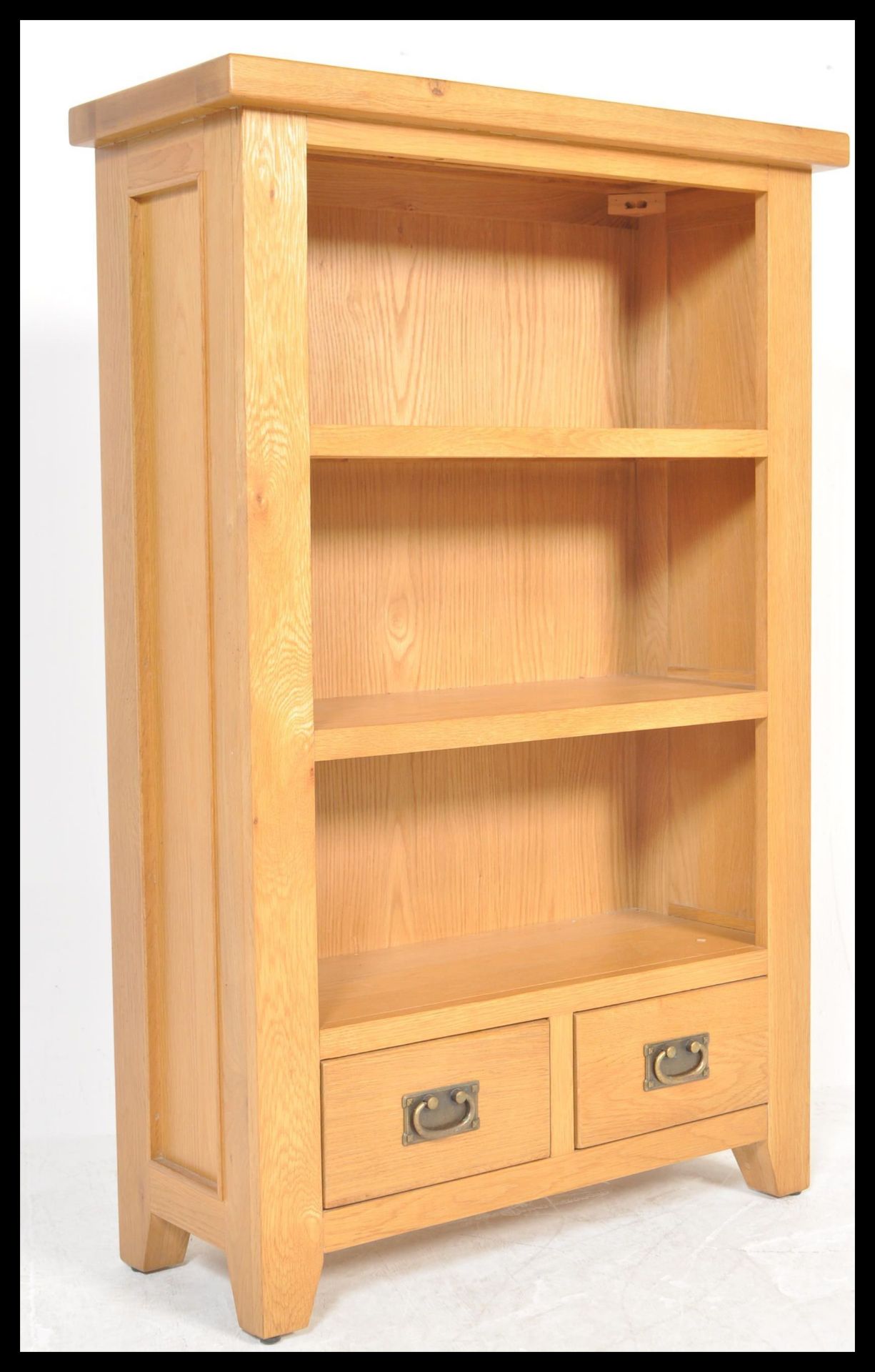 A contemporary chunk oak furniture land style upright wine cabinet bookcase. The top with