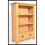 A contemporary chunk oak furniture land style upright wine cabinet bookcase. The top with