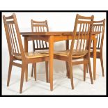 A vintage retro 20th Century teak Danish influence dining table suite with a set of four vintage