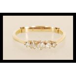 A stamped 18ct gold ring prong set with five diamonds, with a stamped 9ct size adjuster. Weight 2.