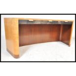 A 20th Century Art Deco solid maple wood desk having a bowed front with large open knee hole recess.