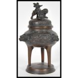 A 19th Century Chinese bronze censer ding incense burner raised on circular base with Foo dog mask