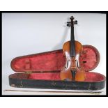 A vintage early 20th Century violin musical instrument having a single piece maple back with