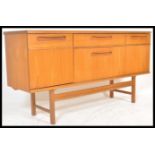 A retro 20th Century teak wood sideboard / credenza by Nathan,having a configuration of drawers