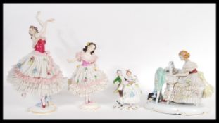 A selection of early 20th Century German Volkstedt china figurines to include a ballerina figurine