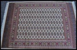 A 20th Century Kejhan Persian Islamic floor carpet rug having a red ground with a central cream