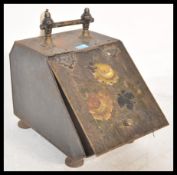 An early 20th Century tin coal scuttle / purdonium having a brass handle to the top and hinged