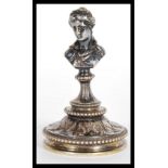 A 19th Century silver plated figural paperweight in the form of a lady or classical maiden raised on