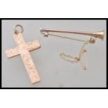 A hallmarked 9ct gold crucifix pendant along with a 9ct gold stamped bar brooch in the form of a