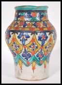 A vintage 20th Century ceramic / pottery Persian baluster vase decorated with fauna details in