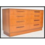 A 1970's G-Plan teak wood Kelso Pattern double chest of drawers being raised on an inset plinth with