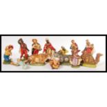 A vintage 20th Century composite Italian nativity set, consisting of Jesus in a crib, three wise