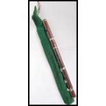 An Edwardian early 20th Century rosewood Flute, having nickel plated keys, kept within a green