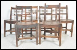 A set of six 19th Century Victorian elm country dining chairs raised on block legs with peripheral