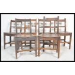 A set of six 19th Century Victorian elm country dining chairs raised on block legs with peripheral