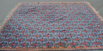 A very large 20th century floor carpet rug having a blue ground with central medallions, pink floral