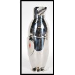 A novelty silver plated cocktail shaker in the form of a penguin wearing a bow tie. Measures 22.