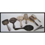 A collection of hallmarked silver vanity items to include various brushes, mirrors etc. along with a