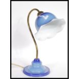 A vintage retro 20th Century enamel table lamp raised on stepped circular base with flared epndant