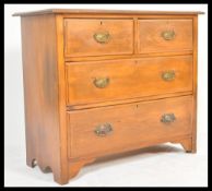 A late 19th Century Victorian mahogany  two over two chest of drawers with shaped swing handles