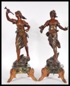 A pair of 20th Century bronzed cast metal figurines in the form of two Grecian style women, one