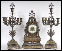 A 19th Century Victorian clock and garniture set consisting of a brass mantel clock having gilt