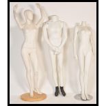 A collection of three 20th Century shop display female and male mannequins dummies, each with