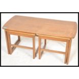 A retro 20th Century teak wood Danish inspired occasional coffee nest of tables consisting of long