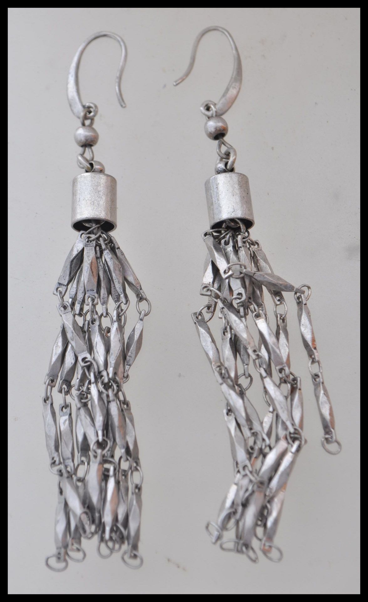 A pair of silver drop earrings having faceted link chain drops. Weight 17.9g. Measures approx 9cm.