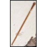 An early 20th Century carved walking stick cane having a twist design to the staff with large